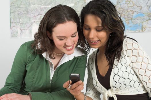 Girls reading a text message on a cellphone