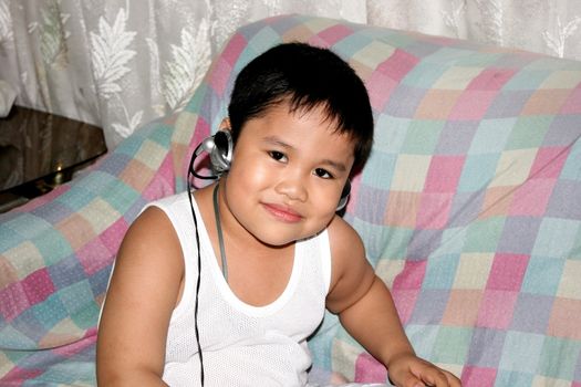 close-up of cute asian kid smiling with colorful background
