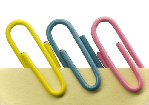 Paperclips on a yellow note with white background