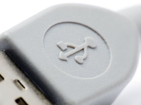 Extreme macroshot of an USB connector clearly showing the USB symbol