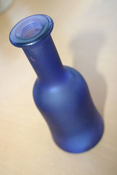 blue glass bottle over a light background