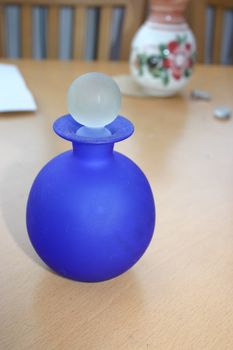 blue glass bottle on a table