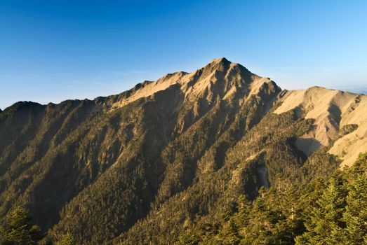 It is a beautiful high mountain with blue sky.