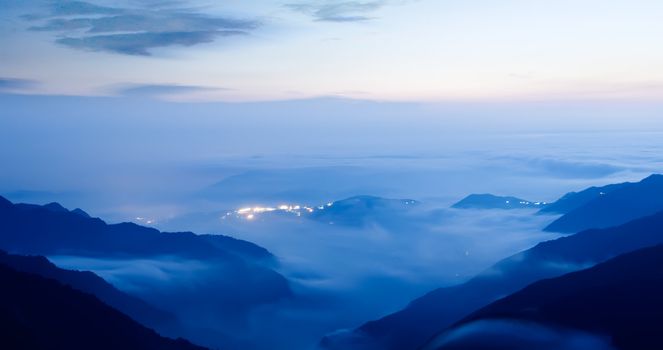 It is a peaceful small town with clouds in night.