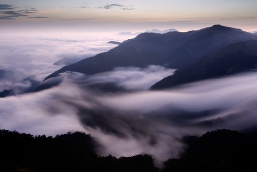 It is beautiful mountain landscape full of clouds.