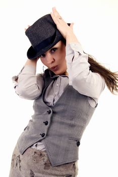 Portrait of a young coquettish brunette in hat posing