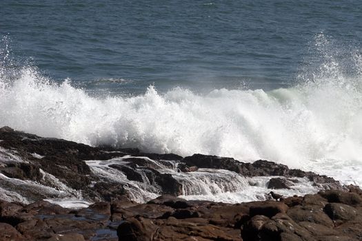 Pacific Ocean. Wave crashing on the shore at Arica harbor, Chile