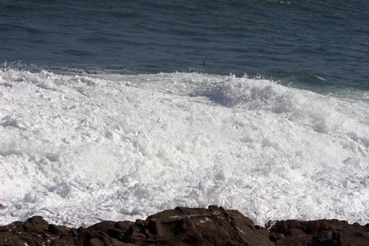 Wave retreating from the shore at Arica harbor, Chile, Pacific Ocean