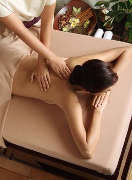 Woman in a day spa getting a deep tissue massage