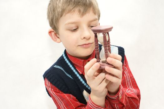 Young boy with old sandglass