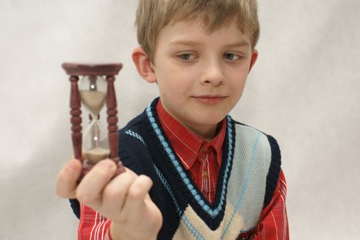 Young boy with old sandglass