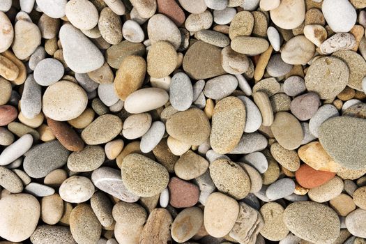 Smooth pebble background from a beach shore.