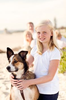 Cute Girl Playing with Her Dog at the Beach.