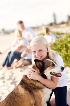 Cute Girl Playing with Her Dog at the Beach.