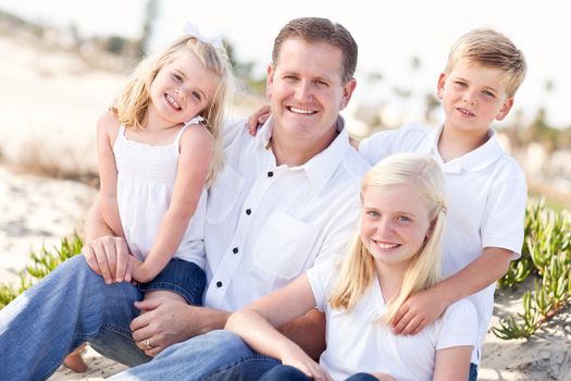 Handsome Dad and His Cute Children Portrait at The Beach.