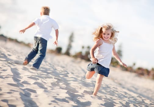 Adorable Brother and Sister Having Fun at the Beach One Sunny Afternoon.