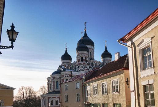 Greek Orthodox cathedral of Alexander Nevsky in Tallinn Estonia over the tops of old houses and the town wall. Taken in HDR to enhance detail