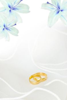 wedding invitation or greeting card blank with lily flowers and golden rings