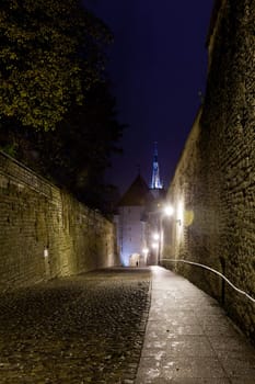 Luhike street leads to the old town of Toompea in Tallinn Estonia on a wet dark night