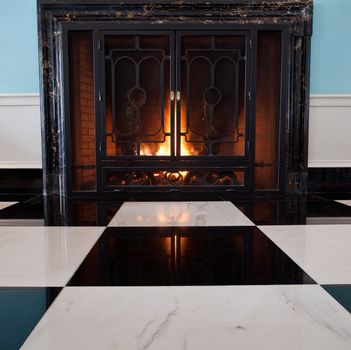 Logs burning in old fireplace in 19th century house