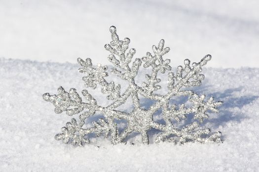 beautiful silver snowflake in snow