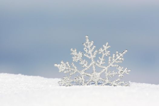 beautiful silver snowflake in snow