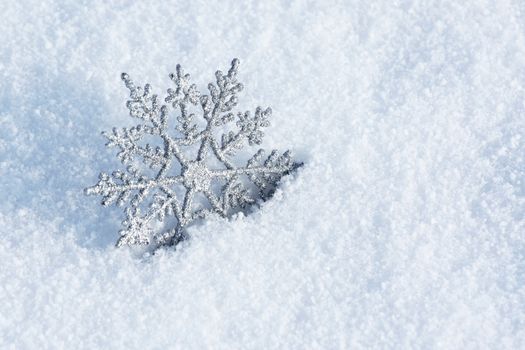 beautiful silver snowflake in snow