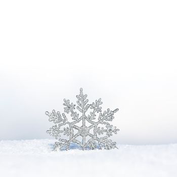 beautiful silver snowflake in snow