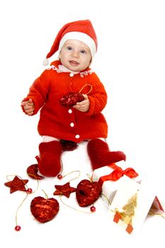 Baby dressed as Santa helper with Christmas decoration