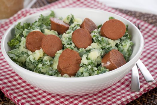 Dutch stamppot, mashed potatoes with kale, topped with vegetarian sausage.