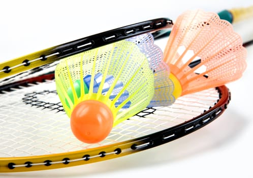 Badminton racquets with shuttlecock on white background