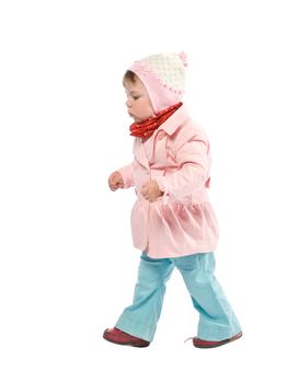 Child walking with pink jacket. Isolated on white