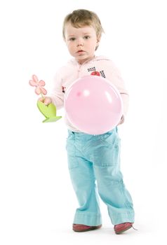 Child with pink jacket, pink balloon, wooden flower. Isolated on white