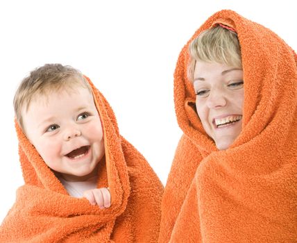 Daughter and mother muffled in orange towel.