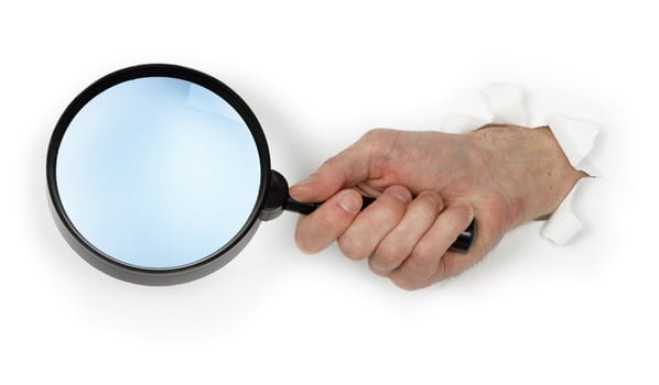 A large magnifying glass in hand isolated on white background