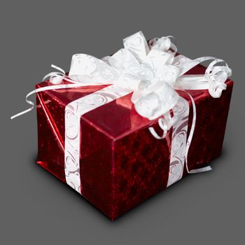 New Year's gift in a red box with a ribbon on a gray background