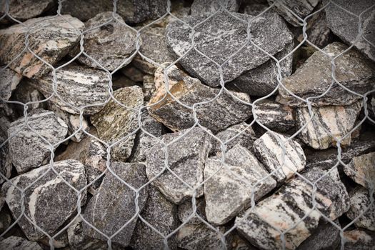 Road embankment of gravel reinforced with steel mesh - industrial background