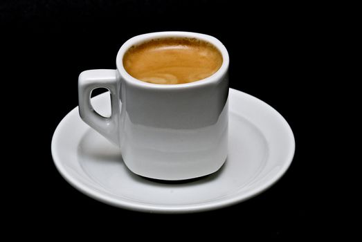 A cup of coffee on a black background.