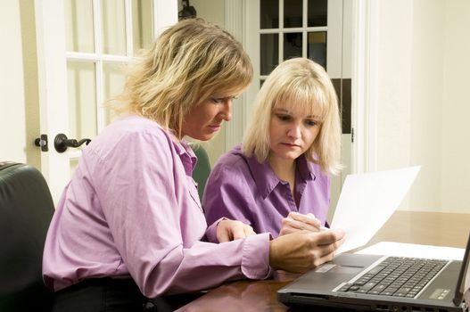 women with a laptop working together as a team