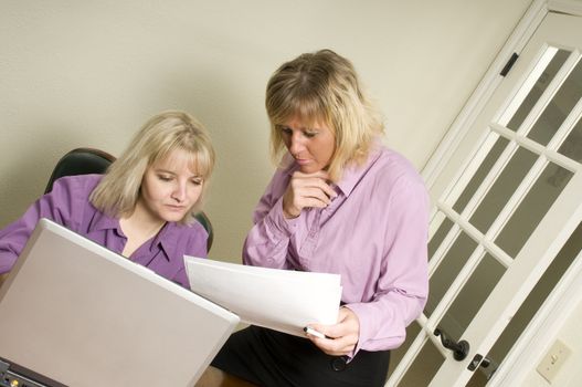 Women using a laptop as a team working on a project