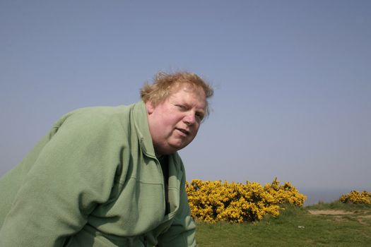 large man on the cliff tops