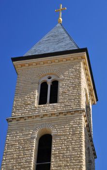 a tall curch tower against a bright blue sky