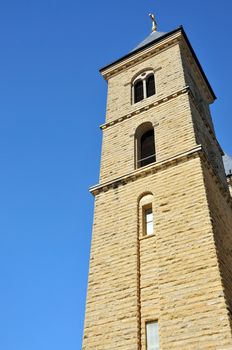 An old stone church tower reaches to the sky