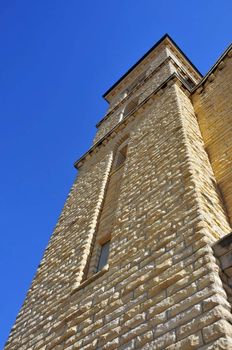 an old stone church tower reaches to the sky