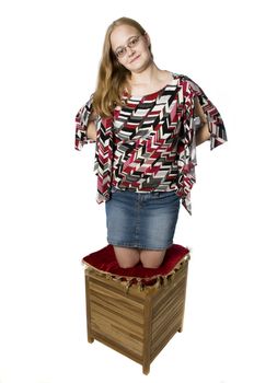 young woman on a wooden box and pillow