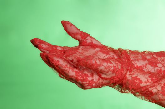 Open womans hands with red gloves against a green screen