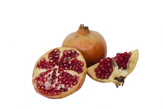 Fresh ripe pomegranate whole and half in isolated over white background