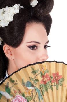 Portrait of the girl of the Asian appearance with a make-up under the geisha on a white background