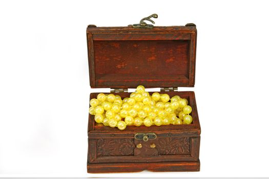 Open wooden box with necklace on bright background