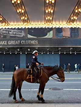 policeman on horse in front of theater, times square, nyc